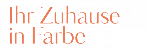 Text mit der Aufschrift „Ihr Zuhause in Farbe“ in eleganter oranger Schrift auf weißem Hintergrund.