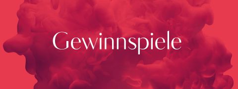 Das Bild zeigt das Wort „Gewinnspiele“ in weißer Schrift zentriert auf einem abstrakten, rauchigen Hintergrund in Rot und Rosa.