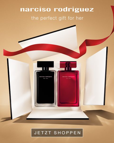 Zwei Parfümflaschen, eine schwarze und eine rosafarbene, in einem offenen Geschenkkarton mit roter Schleife und dem Text "narciso rodriguez - das perfekte Geschenk für sie".