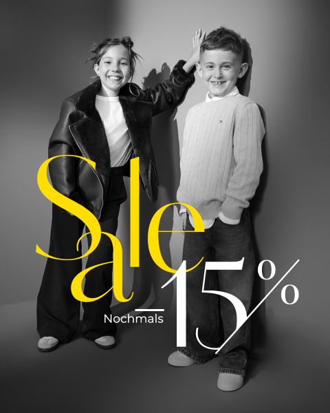 Zwei lächelnde Kinder posieren in stilvollen Outfits vor einem grauen Hintergrund. Der Text lautet "Sale 15% Nochmal.