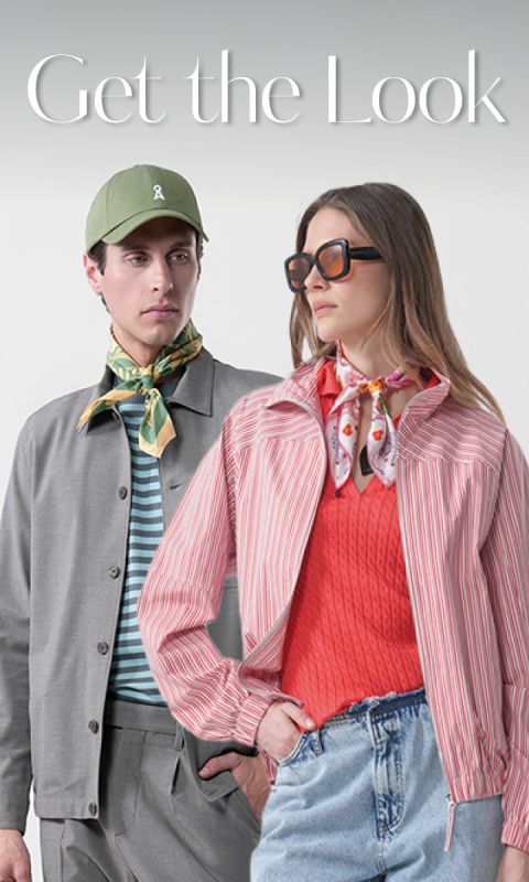 Mann in grauer Jacke und grüner Mütze steht neben einer Frau mit Sonnenbrille, rotem Oberteil und gestreifter Jacke; beide tragen gemusterte Schals. Text: "Get the Look.