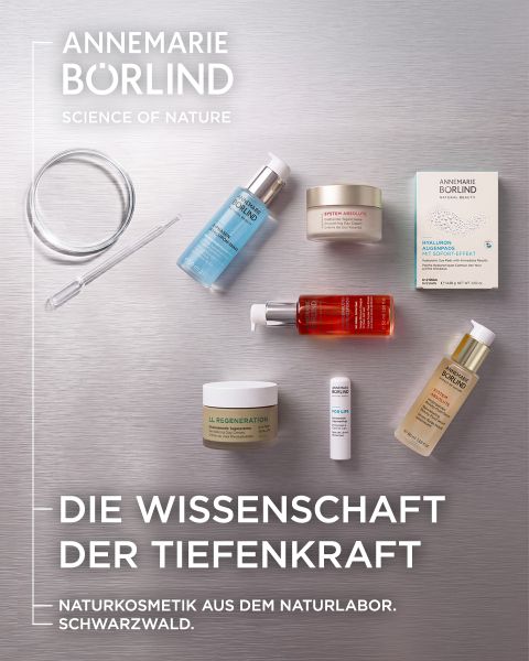 Verschiedene Hautpflegeprodukte von Annemarie Börlind, arrangiert auf einer grauen Fläche mit einer durchsichtigen Pipette und einem deutschen Text über Naturkosmetik und Wissenschaft.